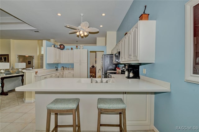 kitchen featuring a kitchen breakfast bar, kitchen peninsula, and stainless steel appliances