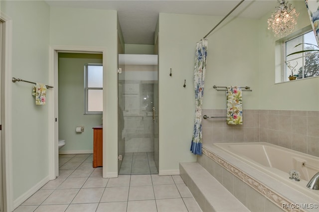 bathroom featuring tile patterned flooring, toilet, plus walk in shower, and an inviting chandelier