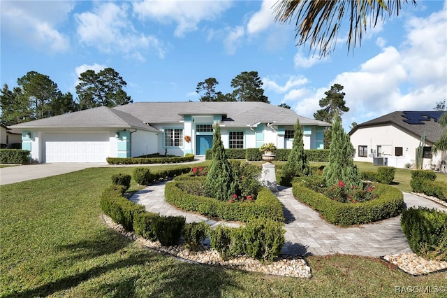 view of front of home with a garage and a front lawn