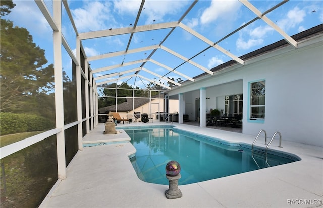 view of pool with a lanai and a patio area