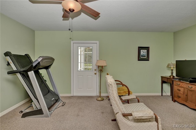 workout room with light carpet and ceiling fan