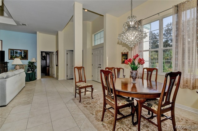 dining room with a notable chandelier and light tile patterned flooring