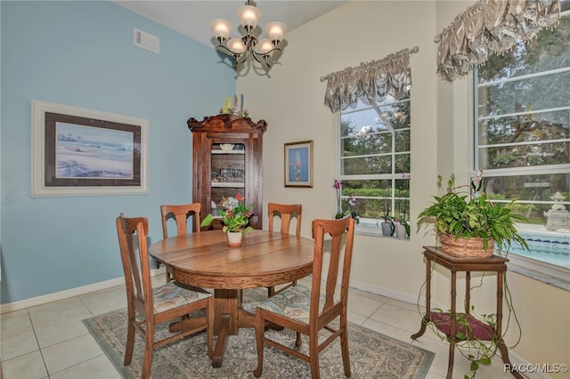 tiled dining area featuring an inviting chandelier