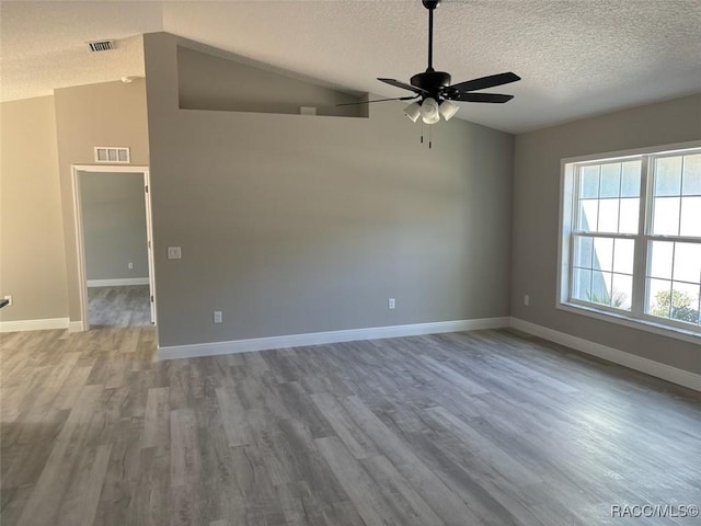 unfurnished room featuring visible vents, a ceiling fan, and lofted ceiling