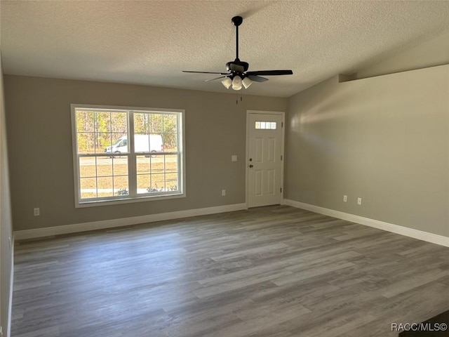 foyer with baseboards, ceiling fan, and wood finished floors