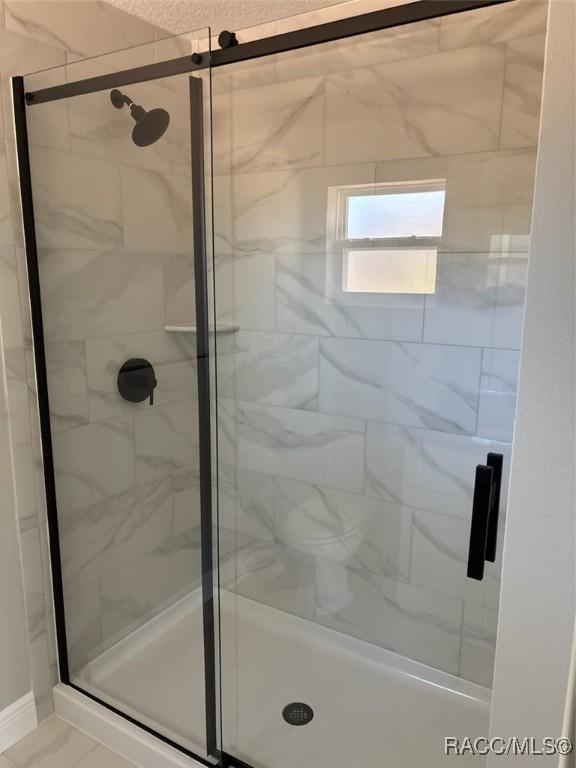 bathroom with a shower stall