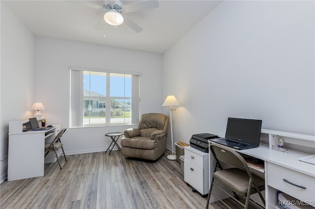 home office with ceiling fan, light hardwood / wood-style floors, and vaulted ceiling