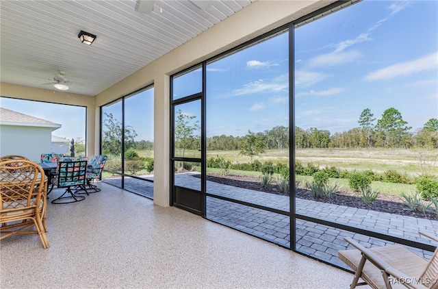 sunroom featuring ceiling fan