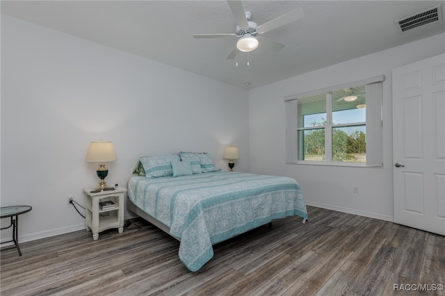 bedroom with ceiling fan and dark hardwood / wood-style floors