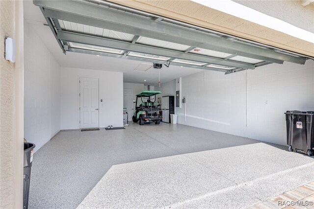 garage featuring electric panel and a garage door opener