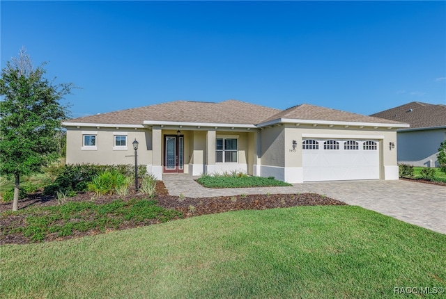 ranch-style house with a porch, a front yard, and a garage