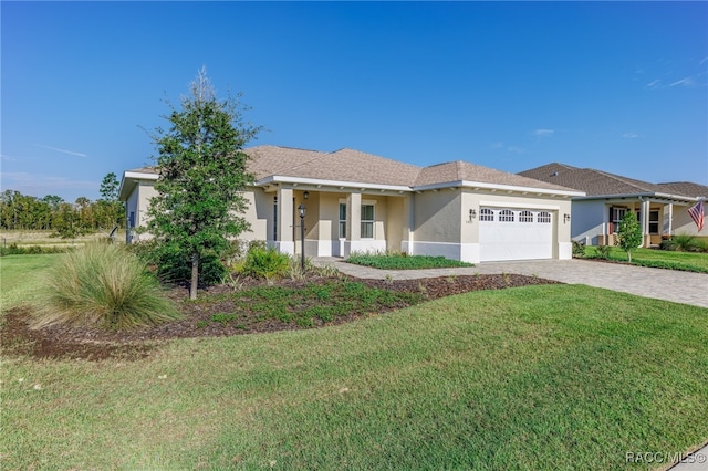 view of front of property featuring a front lawn, covered porch, and a garage