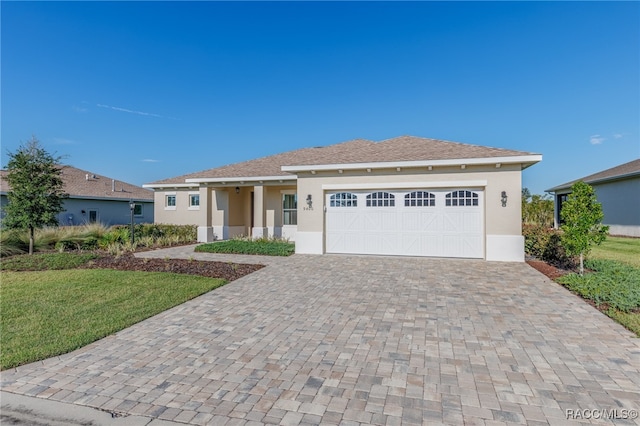 view of front of house with a garage and a front lawn