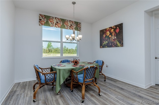 dining area featuring a chandelier and hardwood / wood-style flooring