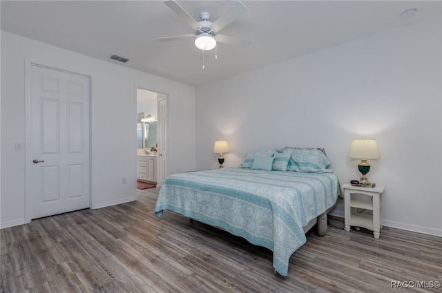 bedroom with connected bathroom, ceiling fan, and hardwood / wood-style floors