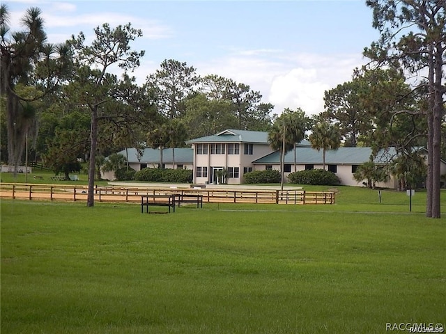 view of property's community with a rural view and a lawn