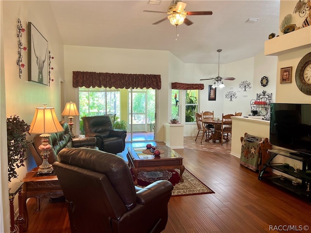 living room featuring ceiling fan and dark hardwood / wood-style flooring