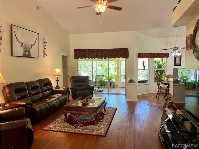 living room with dark hardwood / wood-style floors and ceiling fan