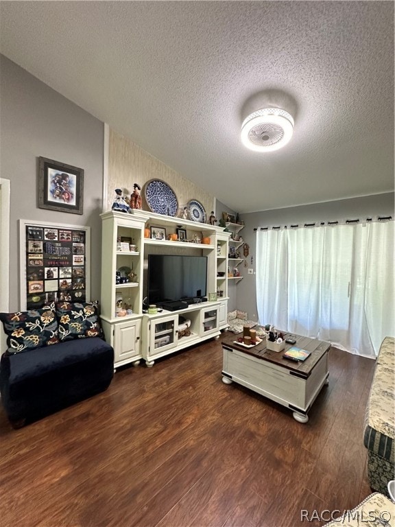 living room featuring dark hardwood / wood-style floors and a textured ceiling