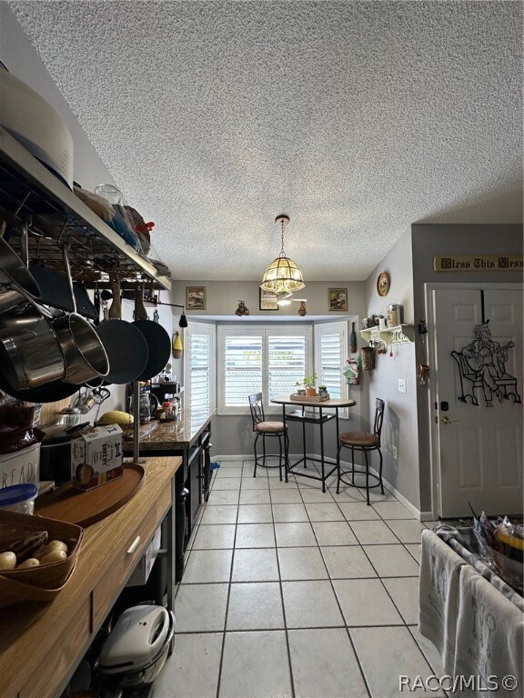 kitchen featuring light tile patterned floors and a textured ceiling