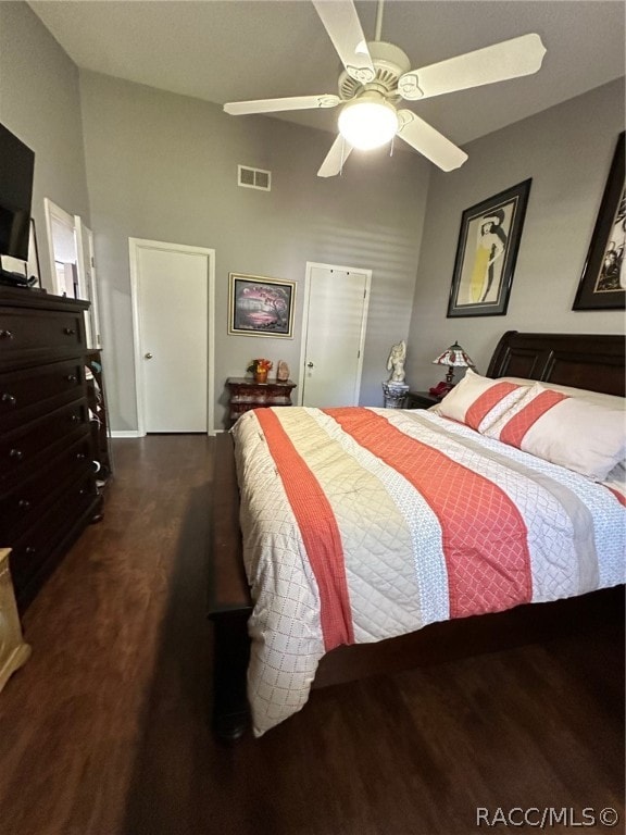 bedroom with ceiling fan and dark hardwood / wood-style flooring