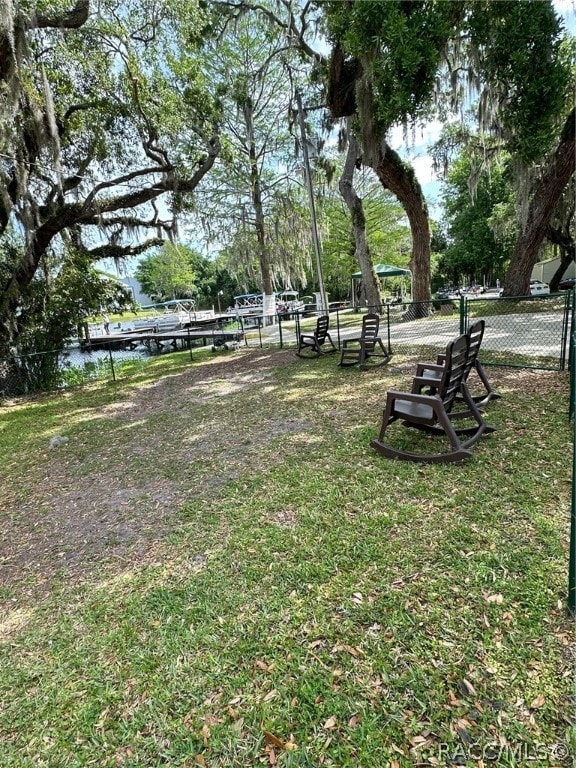 view of home's community with a yard and a water view