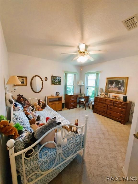 9120 SW 193rd Cir, Dunnellon, FL 34432 - bedroom featuring carpet floors, a closet, and ceiling fan