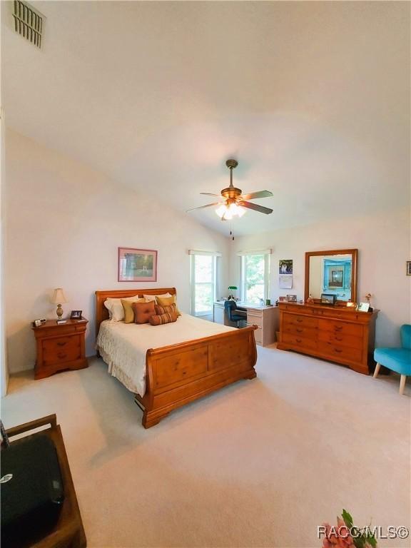 9120 SW 193rd Cir, Dunnellon, FL 34432 - bedroom featuring vaulted ceiling, light colored carpet, an office area, ensuite bathroom, and baseboards