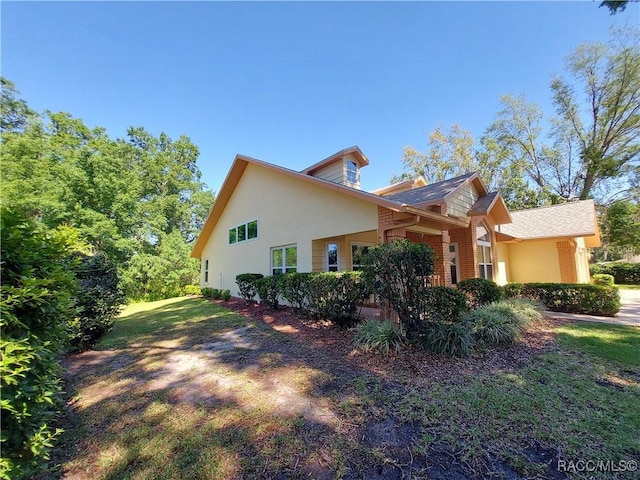 9120 SW 193rd Cir, Dunnellon, FL 34432 - rear view of property with stucco siding, a yard, and a lanai