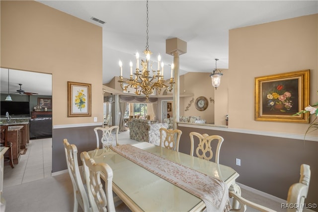 dining area featuring ceiling fan with notable chandelier, high vaulted ceiling, and light tile patterned flooring