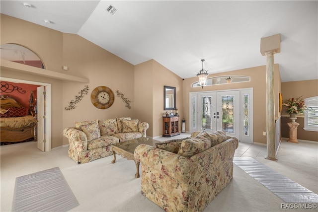 carpeted living room featuring ornate columns, french doors, and lofted ceiling