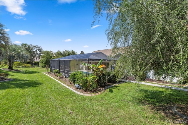 view of yard with a lanai