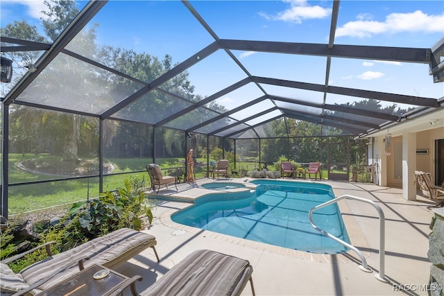 view of swimming pool featuring an in ground hot tub, a patio, and a lanai