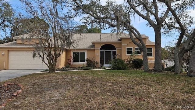 ranch-style home with a garage and a front yard