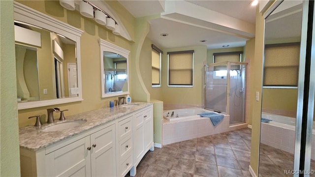 bathroom featuring plus walk in shower, vanity, and tile patterned floors