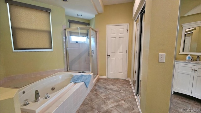 bathroom with vanity, tile patterned flooring, and plus walk in shower