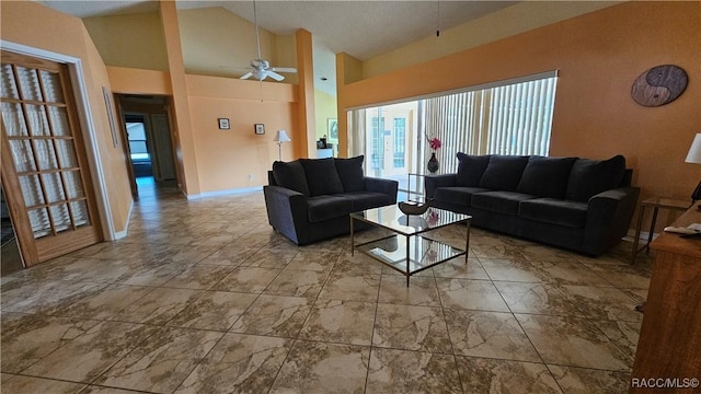 living room with ceiling fan and high vaulted ceiling