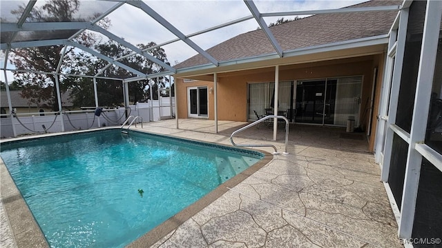 view of swimming pool featuring a lanai and a patio