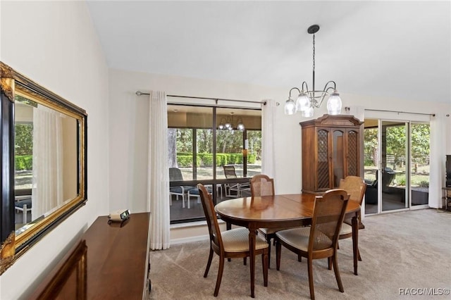 dining space featuring light carpet, a notable chandelier, and a wealth of natural light