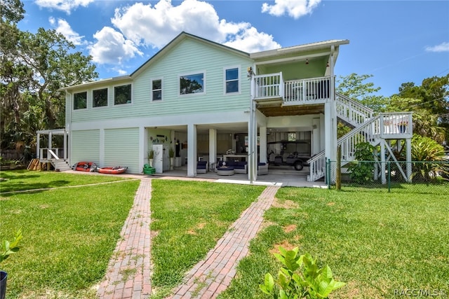 back of house with a patio area and a yard