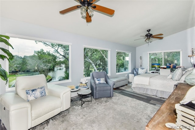 bedroom with ceiling fan, lofted ceiling, and multiple windows