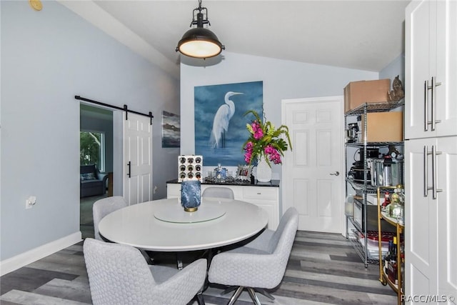 2247 S Waterman Dr, Crystal River, FL 34429 - dining area featuring dark wood finished floors, lofted ceiling, a barn door, and baseboards