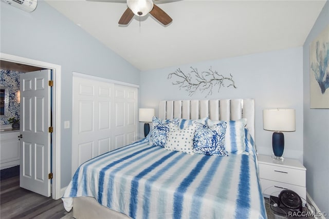 bedroom featuring lofted ceiling, dark hardwood / wood-style floors, ceiling fan, a wall unit AC, and a closet