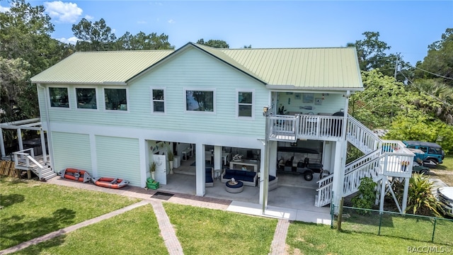 rear view of house featuring outdoor lounge area, a yard, and a patio