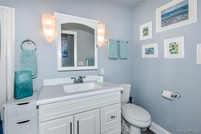 bathroom featuring vanity and toilet