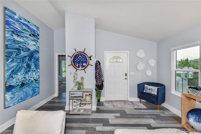 foyer entrance with dark wood-type flooring and lofted ceiling