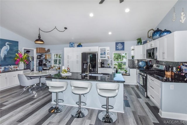 2247 S Waterman Dr, Crystal River, FL 34429 - kitchen with appliances with stainless steel finishes, decorative backsplash, a kitchen breakfast bar, recessed lighting, and vaulted ceiling