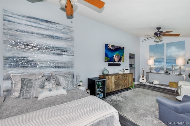 bedroom with ceiling fan, wood-type flooring, and vaulted ceiling