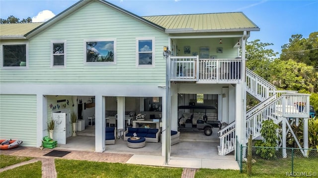 2247 S Waterman Dr, Crystal River, FL 34429 - rear view of house featuring stairs, a patio, metal roof, and an outdoor living space