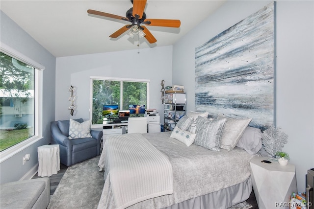 bedroom featuring multiple windows, ceiling fan, hardwood / wood-style floors, and vaulted ceiling